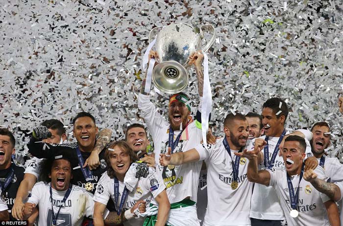 Sergio Ramos lifts the Champions League trophy after Real Madrid came out on top in the penalty shootout against Atletico Madrid.