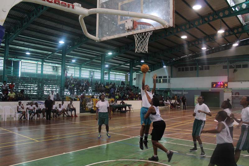 Bishops’ Sileena Arjune (with ball) about to release a jumper in the paint on Sunday against Tutorial High at the Cliff Anderson Sports Hall in the NSBF Regionals.