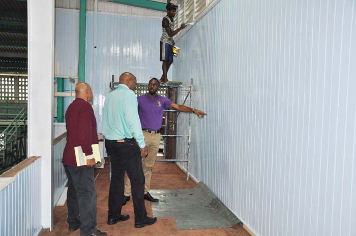 Director of Sport, Christopher Jones (right) makes a point during yesterday’s inspection of works at the Cliff Anderson Sports Hall with GABF President, Nigel Hinds (centre) and manager of the facility, Bashur Khan.