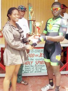 Jebon Crawford receives his reward from female cyclist Marica Dick.  