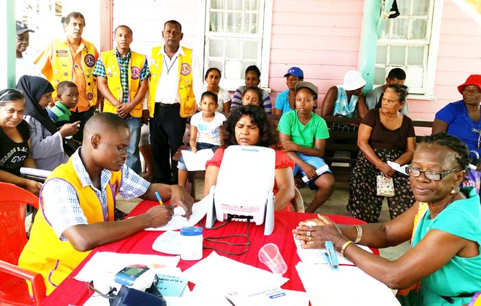 Members of the Lions Clubs in New Amsterdam and East Canje Districts with residents who turned up for free spectacles. 