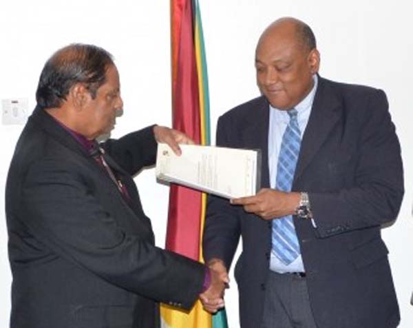 From left: Prime Minister, Moses Nagamootoo receives Code of Conduct from Minister Raphael Trotman
