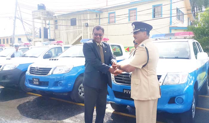 Ramnarine receives the keys for the vehicles on behalf of the force from the Minister.