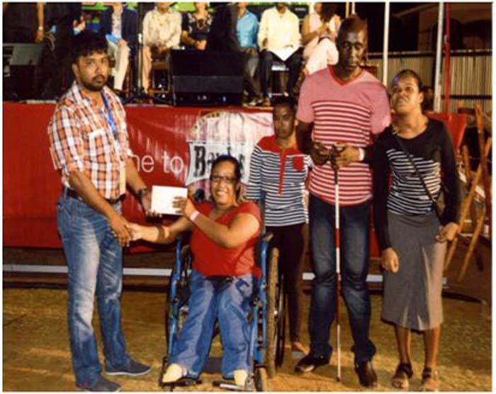 Secretary of the Chamber Mr. Hardat Malchand makes a presentation to members of the Special Needs and Disability Home of Seafield Village, West Coast Berbice.