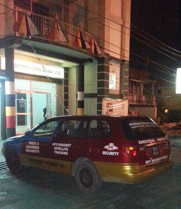 The abandoned security service car outside the bank.