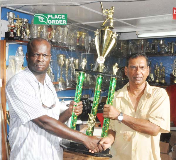 Trophy Stall Managing Director Ramesh Sunich (right) presents the winning trophy to Samuel Kingston.