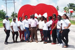 Dr. Lewis Centre, flanked by staff members of the National Blood Transfusion Service