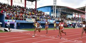 Brenessa Thompson (left) takes the Fly Jamaica Women’s 100m yesterday in a record breaking performance. 