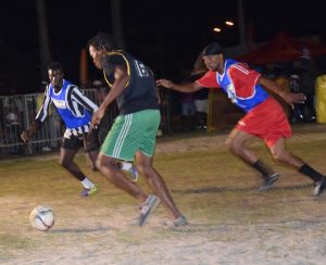 Part of the action between Cross Street and Globe Yard which the latter won on Wednesday night, at the Ministry of Health ground.