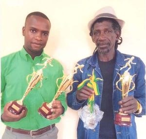 Displaying some of the trophies and medals at stake are Bartica Mayor Gilford Marshall (left) and Organiser Ras Aaron Blackman.