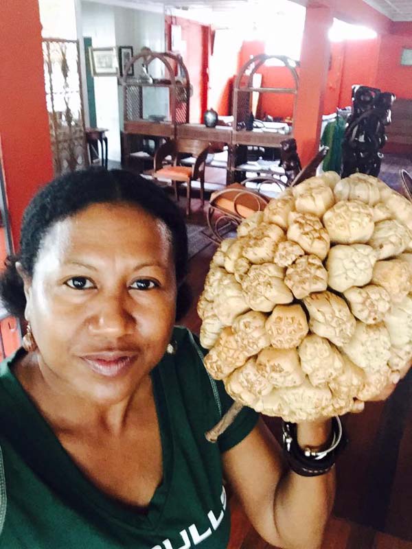 Posing with a Pandanus Fruit