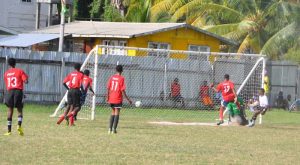 Golden Grove’s Simon Jones (2nd right) scores his school’s first goal in the 14th minute to draw level with IBE at 1-1 yesterday. (Franklin Wilson photo)