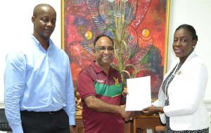Guyana Amazon Warriors Team Operations Manager Mr. Omar Khan holds the contract with Minister within the Ministry of Education, Hon., Nicolette Henry in the presence of Permanent Secretary, Alfred King. 