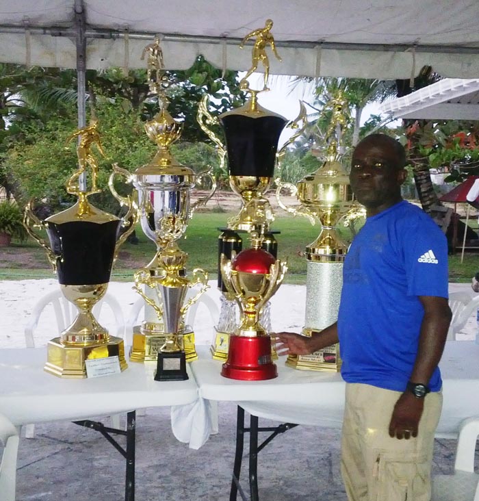 Joseph ‘Bill’ Wilson displaying the trophies won under his guidance.