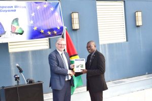 Minister of Public Infrastructure, David Patterson (right), receives the Coastal Engineering Design Manual for Guyana Sea and River Defences from European Union Ambassador, Jernej Videtič.