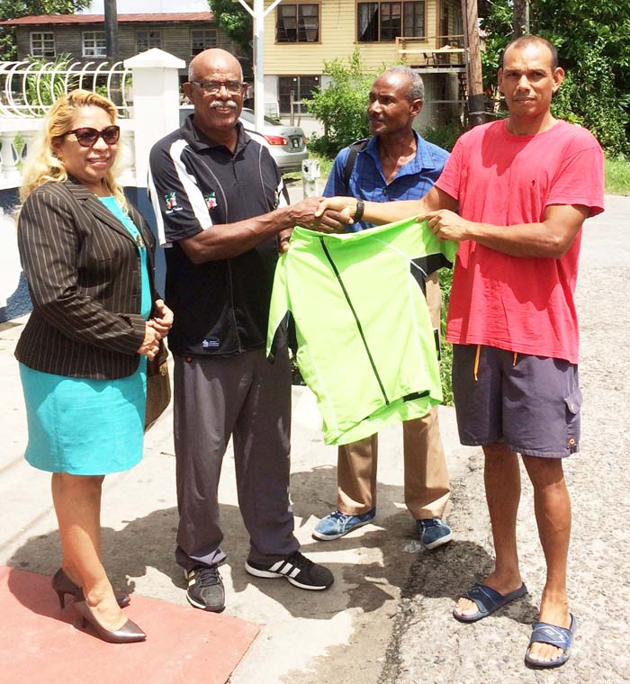 GCANA’s Victor Rutherford (2nd left) hands over one of the National Championships jerseys to GCF VP Paul; Choo-Wee-Nam in the presence of other officials.