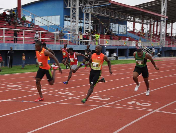 Rupert Perry (left) out-leans GDF team-mate, Akeem Stewart to claim the Men’s 100m title at the National Track and Field Centre, Leonora yesterday. 