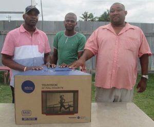  RHTYSC Secretary/CEO Hilbert Foster hands over Television Set to ‘B’ Division Commander Ian Amsterdam and Corporal Haynes of the Police Outpost.