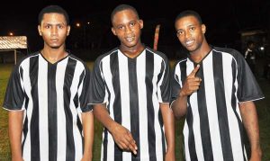 Ryan Hackett (center) is flanked by Shawn Mohamed (left) and Dellon David – Santos FC. 
