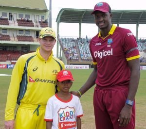 Shiloh Adams stands with Jason Holder and Steve Smith at the toss. (WICB Media Photo/Randy Brooks of Brooks Latouche Photography)