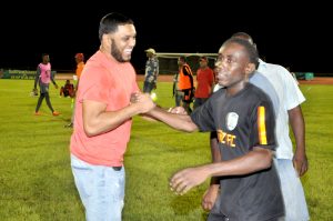Slingerz FC President and Owner, Javid Ali (left) congratulates Devon Millington following his goal that handed them SEL Overall Champion status.