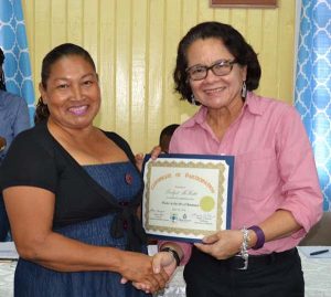 First Lady, Mrs. Sandra Granger presents one of the participants with her Certificate.