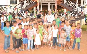President David Granger and First Lady Mrs. Sandra Granger with the children of Surama Village who came out to greet them 