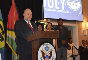 US Ambassador to Guyana, Perry Holloway delivering remarks as Minister of Public Security, Khemraj Ramjattan (right); First Lady, Sandra Granger and the wife of the Prime Minister, Sita Nagamootoo look on. 