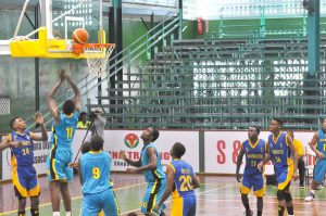 Richard Arthur (#24) of Barbados watches as Samuel Hunter (#11) of Bahamas is about to score. 