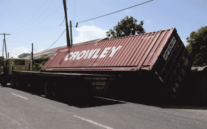 The container tilted on the tray of the truck while leaning against the fence of BL Beer Garden 