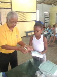 Handing out books during a Rotary Club outreach in Sophia.
