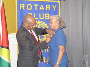 Being pinned by Rotary International District Governor Dr. Hervé Honoré