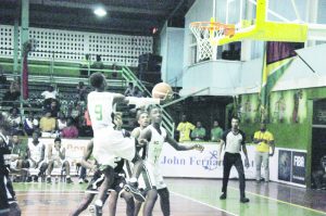Guyana’s Kelmar Carmichael goes up for a lay-up against Trinidad and Tobago last night at the Cliff Anderson Sports Hall.