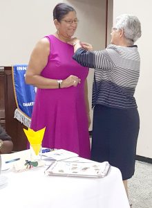 IWC President Dorothy Fraser (right) awards Outgoing IWC President, Mitzy Campbell with the Club's signature pin 