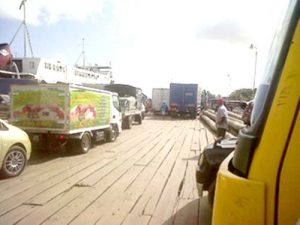 Vehicles preparing to board a ferry at Parika Stelling. 