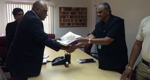 Major General (Ret.) Joe Singh, as he handed over the Reynold Williams CoI report to Minister of Natural Resources, Raphael Trotman. 