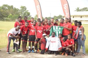 Digicel representative Mario Grimshaw (3rd right standing) hands over the new uniforms to Captain of Christianburg / Wismar Keyshawn Dey in the presence of teammates and supporters yesterday.