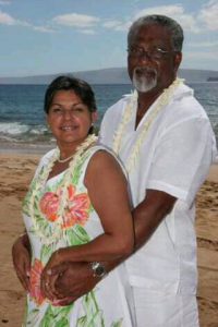 Sadie and her husband Reggie on their wedding day on a beach in Maui, Hawaii