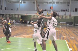 Shauliqua Fahie releases a floater in the lane despite Jada Mohan and Kesann Charles' trap defence in the paint