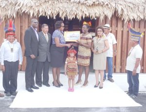 Minister Nicolette Henry (third from right) receiving a drawing of the Umana Yana from Junior Minister of Public Infrastructure, Annette Ferguson 