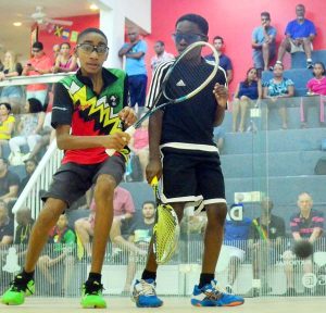 Shomari Wiltshire (left) about to attack the ball in his U13 final match against Darien Benn of Barbados which he won.