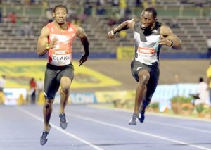 Winner Yohan Blake (L) and Nickel Ashmeade in action during men's 100m final race. (REUTERS/GILBERT BELLAMY)