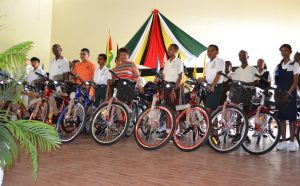 Minister of Social Cohesion, Ms. Amna Ally and some of the Demerara-Mahaica recipients of bicycles and backpacks, this morning, in the Queen’s College auditorium.  