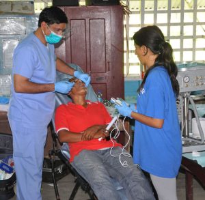 Dr. Chiran Reddy (left) and his assistant Simran Ghooi attend to a patient