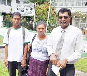Torture victim Twyon Thomas, with his mother Shirley and their Attorney-at-Law Khemraj Ramjattan back in 2012.