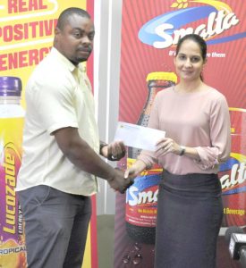 Edison Jefford (left) receives the sponsorship cheque from Ansa McAl’s Non-Alcoholic Brand Manager, Anjeta Hinds yesterday.