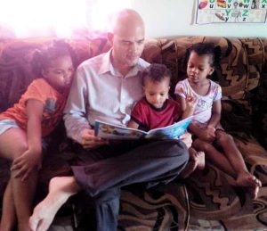Fun reading with his children.