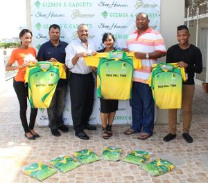 Gizmos and Gadgets Company Secretary Malicia Gomes hands over uniforms to RHTY&SC Secretary/CEO Hilbert Foster in presence of members of the Club and Company.