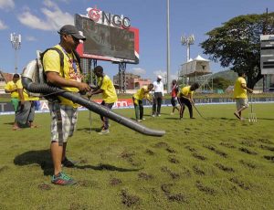 The ground staff at Queen’s Park Oval tried various means to get the outfield fit for play on day three, all in vain © AFP.