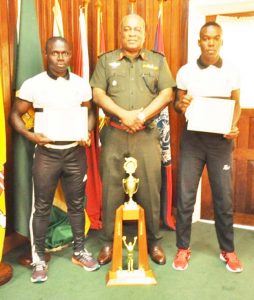 Chief of Staff Brigadier Mark Phillips, flanked by Lance Corporal Carmichael (left) and Lance Corporal Henry.